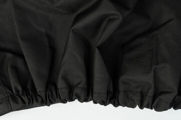 Black fabric with gathered edge showcasing texture and design for sewing projects