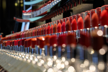 lipsticks of different shades stand in several rows
