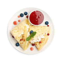 Delicious crepes with cottage cheese, jam, redcurrants and blueberries isolated on white, top view