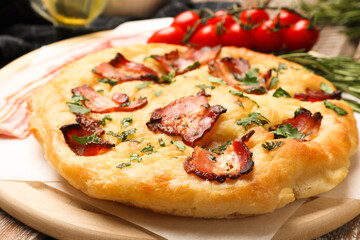 Delicious focaccia bread with bacon and parsley on table, closeup