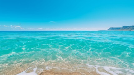 Obraz premium Narrow white sand beach merging seamlessly with bright azure sea under clear skies