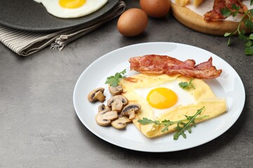Delicious crepe bretonne with bacon, mushrooms and arugula on grey table, closeup