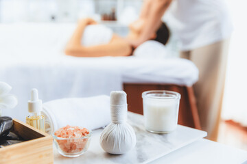 Aromatherapy massage on daylight ambiance or spa salon composition setup with focus decor and spa accessories on blur woman enjoying blissful aroma spa massage in resort or hotel background. Quiescent