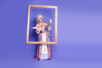 Elegant woman in historical costume holding mobile phone in a classical art frame
