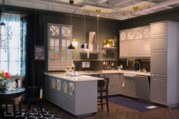 Furniture store showroom. A gray kitchen setup complements a cozy dining area, functionality with aesthetic appeal. 