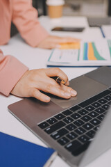 Cropped image of professional businesswoman working at her office via laptop, young female manager using portable computer device while sitting at modern loft, flare light, work process concept