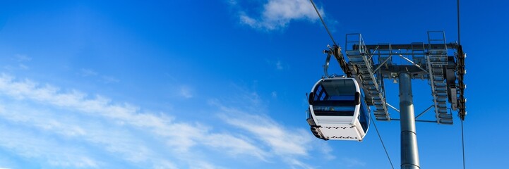 This high-quality image features a modern gondola set against a clear blue sky, ideal for travel and tourism marketing, social media posts, and winter activity promotions.
