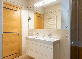 Modern Bathroom Interior with Wooden Door and Double Vanity