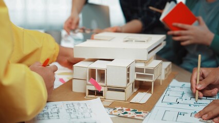A dynamic architectural design session where a diverse group of designers collaborate around a...