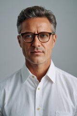 Obraz premium arafed man in a white shirt and glasses looking at the camera