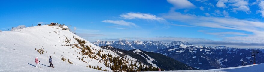 A skilled skier enjoys the fresh powder snow while skiing down a breathtaking mountainside in the...