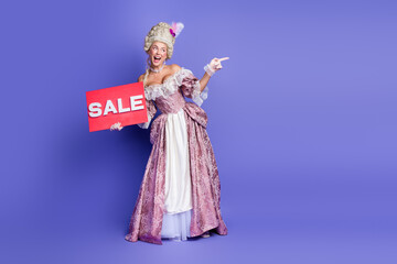 Elegantly Dressed Woman in Baroque Costume Holding Sale Sign on Purple Background