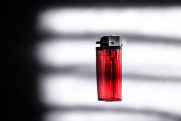 A Lighter in Dramatic Lighting with Shadow Patterns