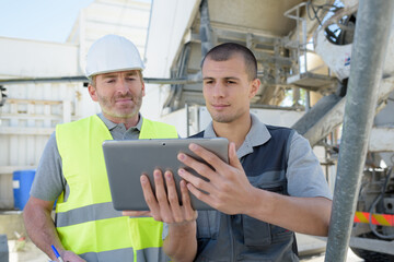 two builders analyzing a tablet