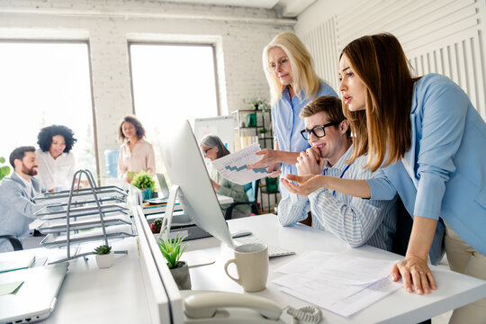 Professionally diverse team collaborating in a modern office space during a business meeting