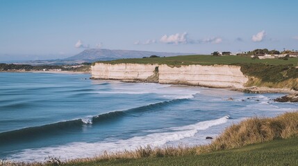 Coastal surf break, cliffs, ocean waves, grassy hillside