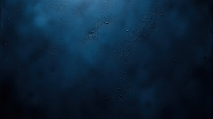 Closeup of water droplets on a dark blue surface, creating a textured and moody background.