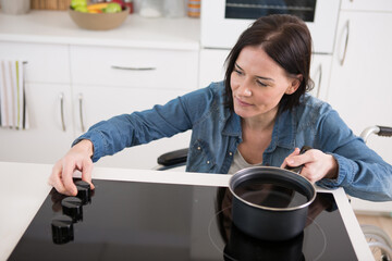 disabled woman in a wheelchair cooking on the hob