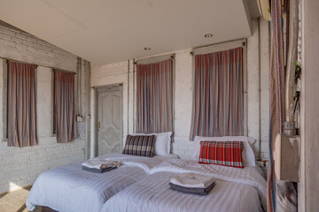 Cozy rustic bedroom with comfortable bed, wooden furniture and a relaxing atmosphere