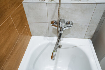 A bathtub with a faucet coming out of it in a bathroom
