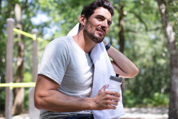 Fototapeta premium man towelling off after exercising outdoors in the sun