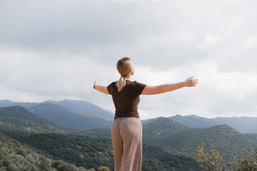 woman  in the mountains, embracing slow living and mindfulness. A moment of balance, self-care, and...