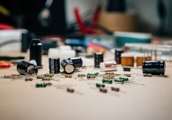 Assorted electronic components including capacitors and resistors on a workbench