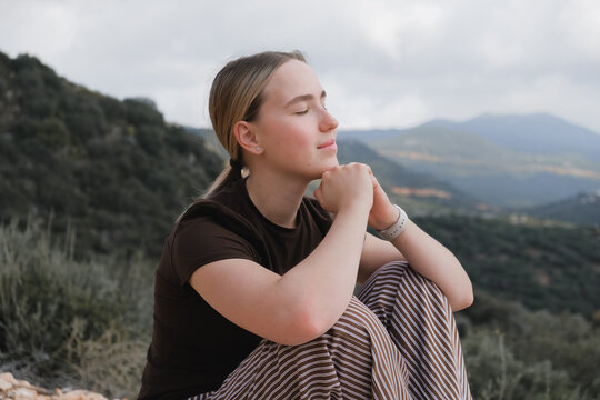 woman  in the mountains, embracing slow living and mindfulness. A moment of balance, self-care, and deep connection with nature. Serenity, mental well-being, and tranquility in an outdoor retreat
