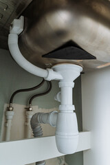 A kitchen sink that features a drain pipe situated beneath it, an essential element of kitchen...
