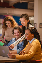 multicultural colleagues work together on laptop in the office