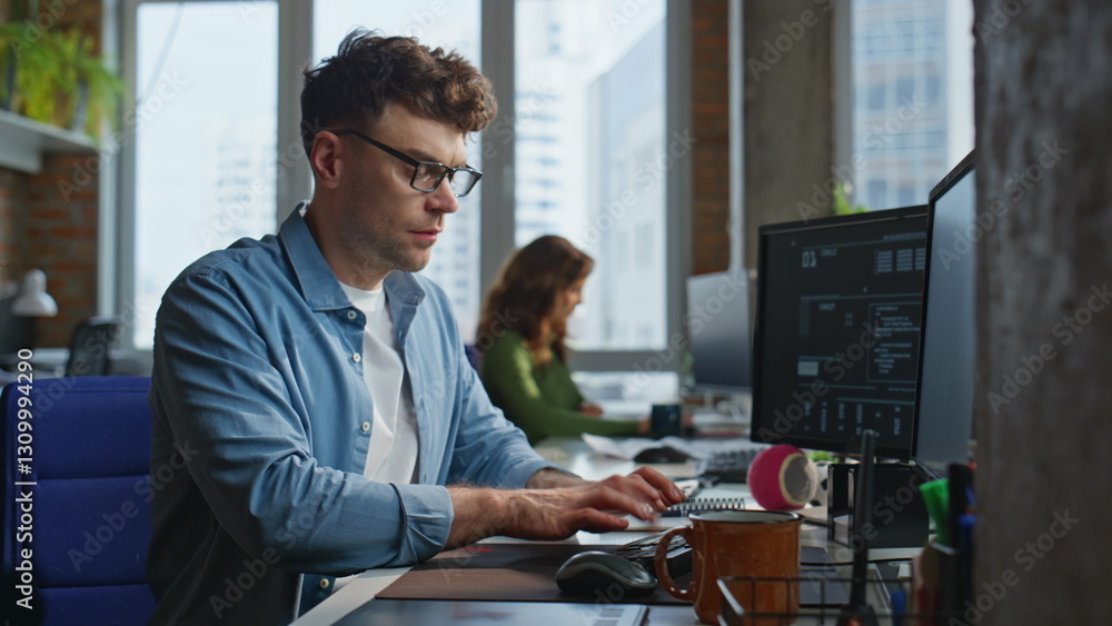 Poster focused man looking desktop at open space closeup. freelancer working computer
