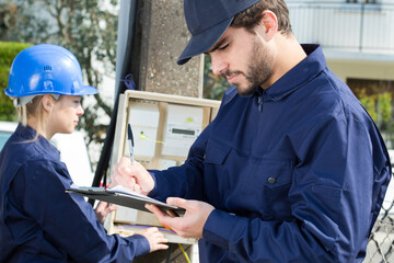portrait of electrician using multimeter