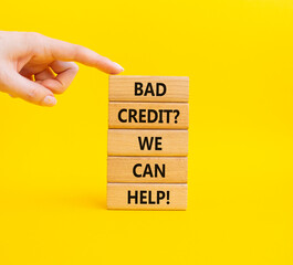Bad credit We can Help symbol. Wooden blocks with words Bad credit We can Help. Businessman hand. Beautiful yellow background. Business and Bad credit We can Help concept. Copy space.