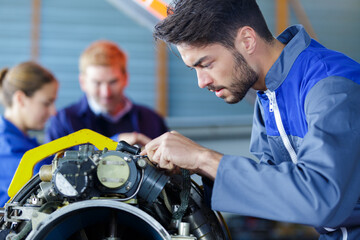 young engineer working on aircraft motor