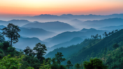 Obraz premium Majestic mountain landscape at sunrise with misty valleys and lush greenery