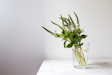 Wedding bouquet or Valentine's Day bouquet of Veronica longifolia in a glass vase on a beige wooden...