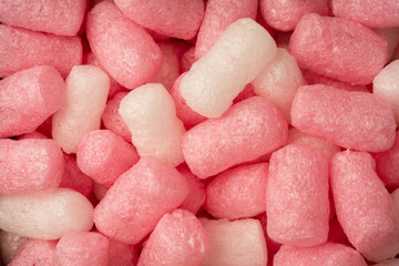 Pink and white box filler as a background. Top view.
