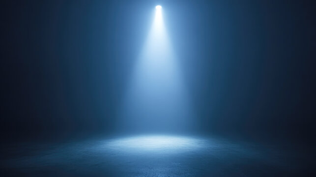 Dramatic spotlight illuminating empty dark stage with blue tones