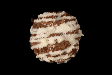 Profiteroles with coconut cream on a black background.