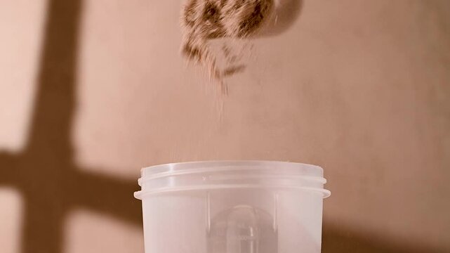 Chocolate protein powder, making a shake. Food supplement, fitness sport, health and nutrition.