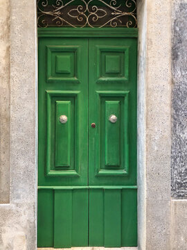 Traditional Green Maltese Wooden Door with silver door knobs - A striking green classic wooden door from Malta, a testament to timeless craftsmanship and traditional Mediterranean style