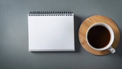Minimalistic Spiral Calendar Mockup Template Showcasing a Gray Background, Coffee Cup, and Branding Elements, Exuding a Modern and Trendy Aesthetic for Advertising and Design Inspiration.