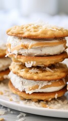 Stacked coconut cream ice cream sandwiches with peanut butter cookies