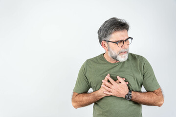 Senior man is having pain in his chest. Heart attack symptoms. Mature man holding his heart in...