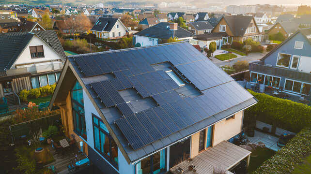 A residential house with solar panels on its roof, capturing renewable energy in a suburban neighborhood ai generated