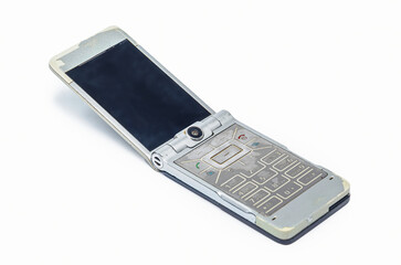 Vintage silver and beige flip phone with worn body on white