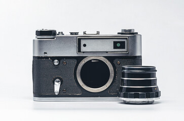 Vintage silver film camera with lens and black leather on white