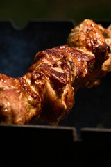 juicy meat (sashlik) is cooking on a grill 