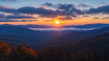 Obraz premium Stunning autumn sunrise over blue ridge mountains with vibrant colors and rolling fog