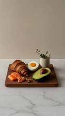 Minimalist still life of a wooden board with golden croissants, avocado, boiled eggs, salmon, and microgreens. Soft lighting, natural textures, and clean white background for a fresh
